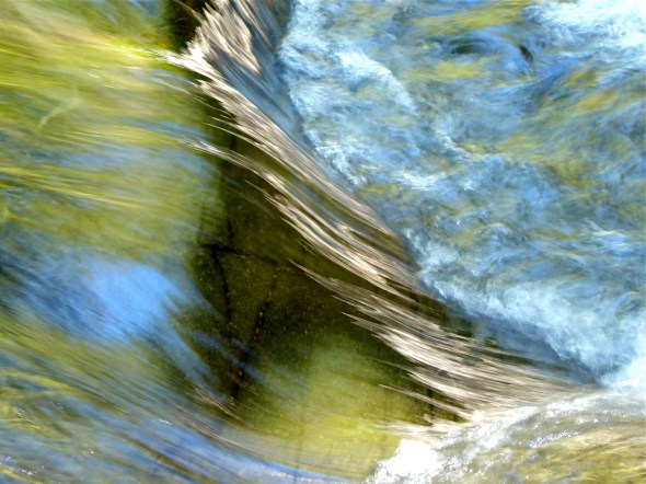 Green water running over rocks