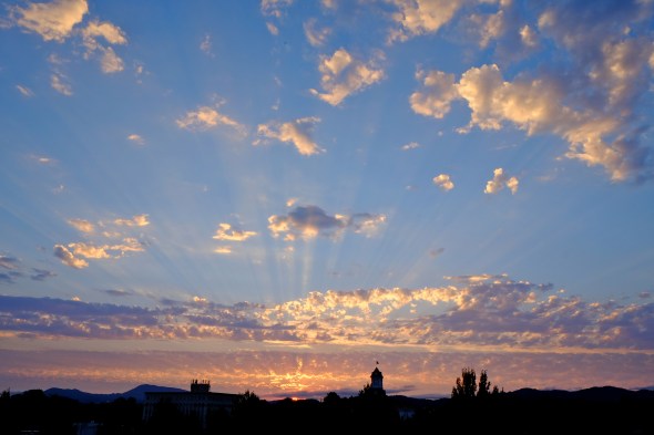 Sunset over town with bright clouds