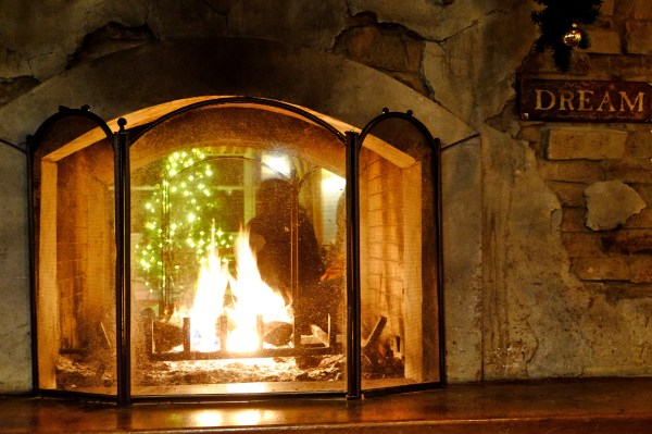 Fire in Fireplace with "Dream" Sign on Hearth