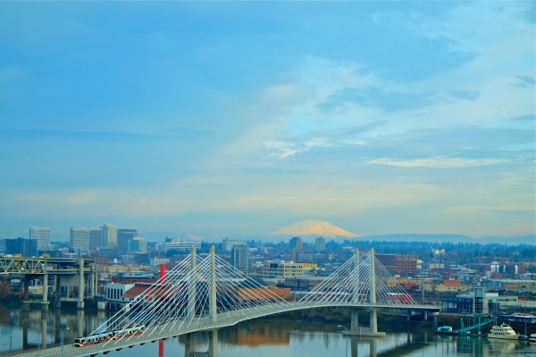Portland, OR, Willamette River, Tilikum Crossing bridge and Mt. St. Helens on partly cloudy winter day