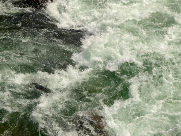 Wild whitewater rapids and green water in river