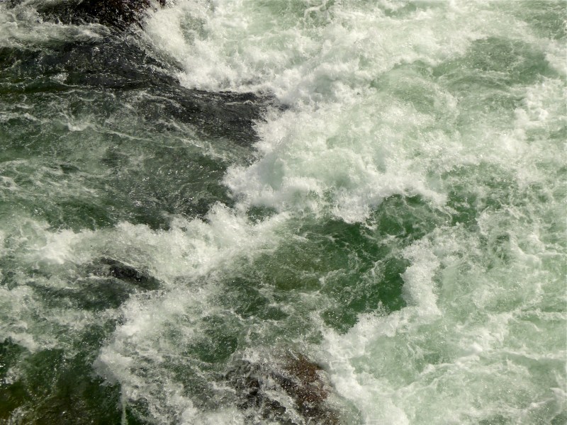 Wild whitewater rapids and green water in river