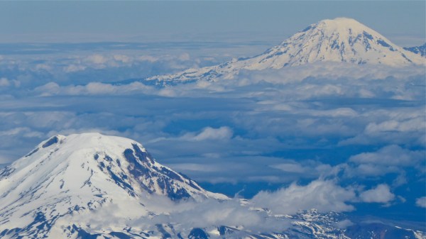 Two snow-capped peaks above the clouds