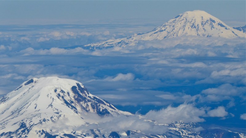 Two snow-capped peaks above the clouds