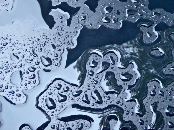 Water drops on black metal table