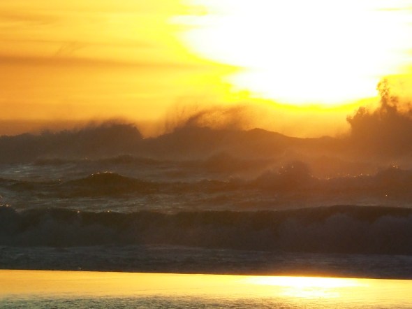Dark Surf, Sun and Orange-Yellow Sky