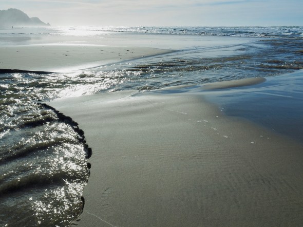 Sandy beach with rocky headlands in distance