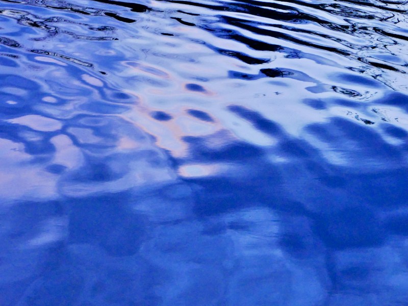 Blue and rosy reflections in lake water