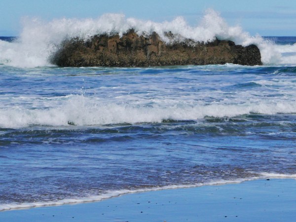 Wave breaking over nearshore rocks