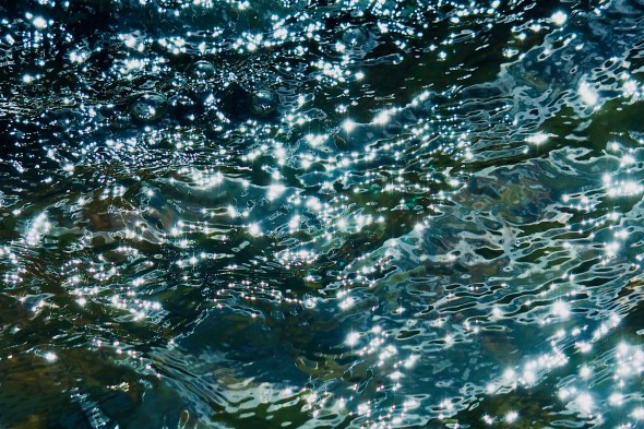 Sunlight sparkling on water in fountain