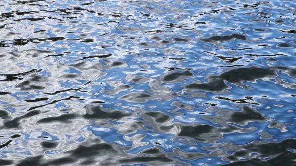 Blue ripples on grey water
