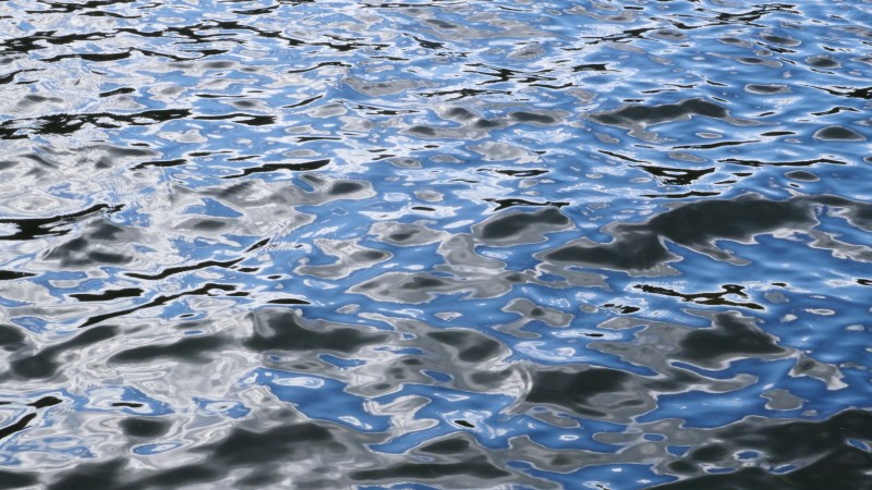 Blue ripples on grey water
