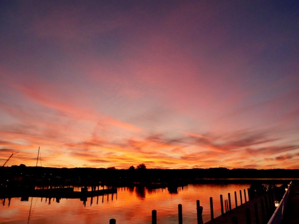 Colorful pastel sky and water after sunset at docks