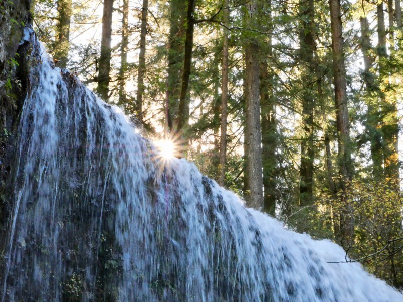 Sun just above top of waterfall