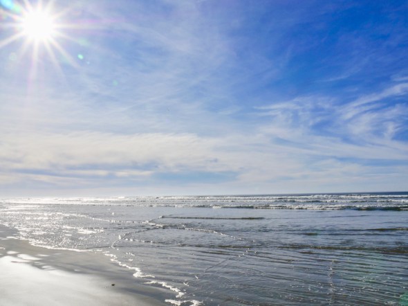 Blue sky and sun on beach and surf