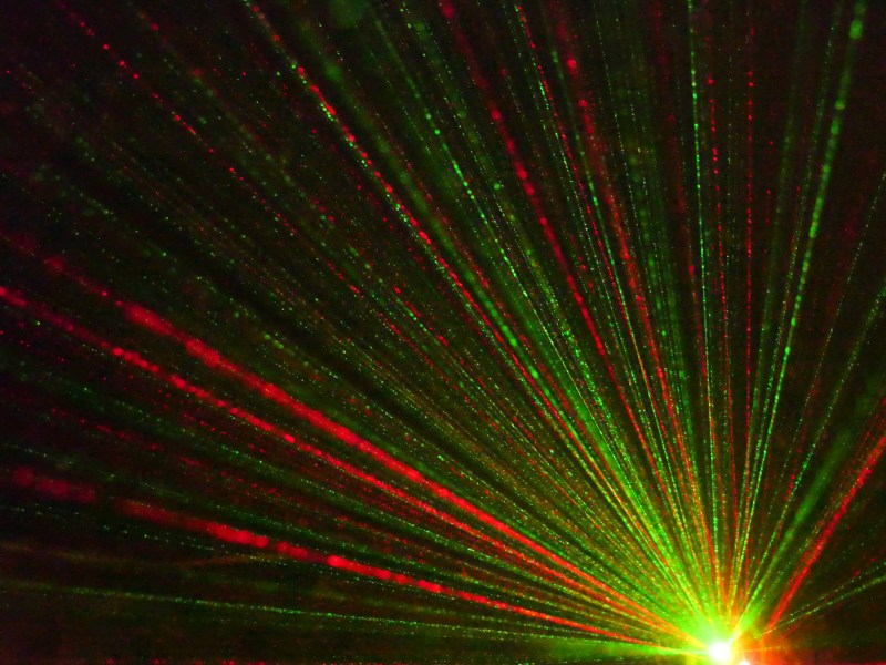 Red and green shafts of light in darkness