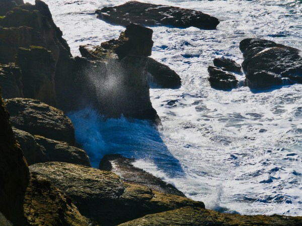 Waves hitting rocky coastline