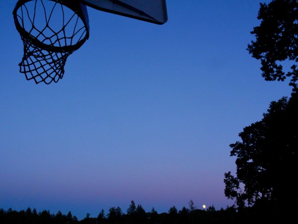 Basketball hoop and full moon rising