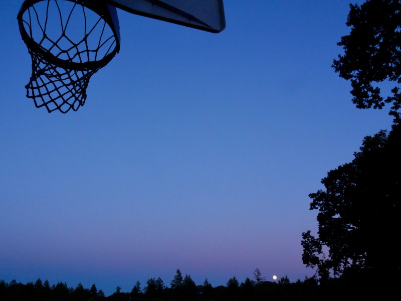Basketball hoop and full moon rising