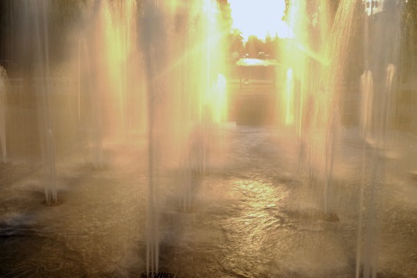 fountain backlit by setting sun