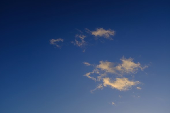 Small white clouds in blue sky