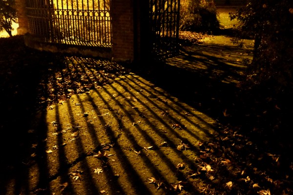 Metal fence and shadows at night