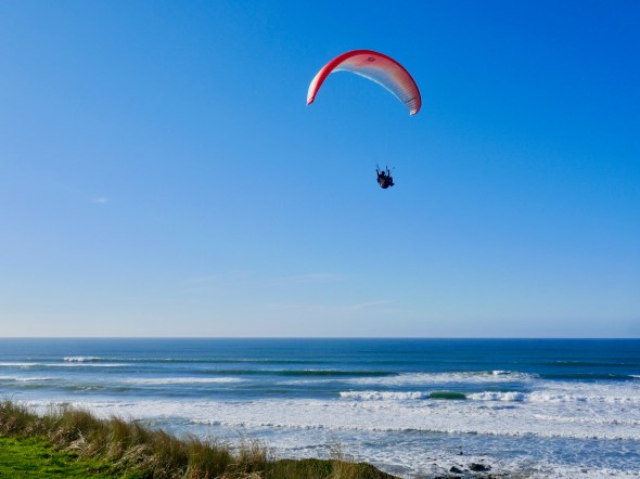 sailboarding over Pacific surf