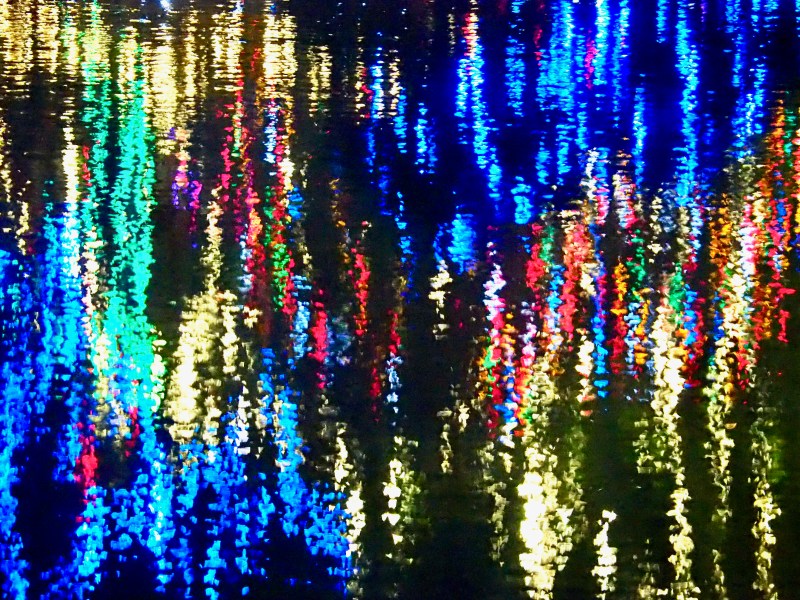 holiday lights reflected in pond