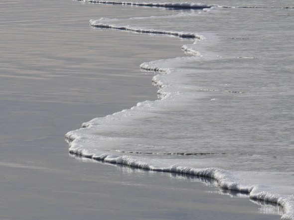 water lapping up on ocean beach