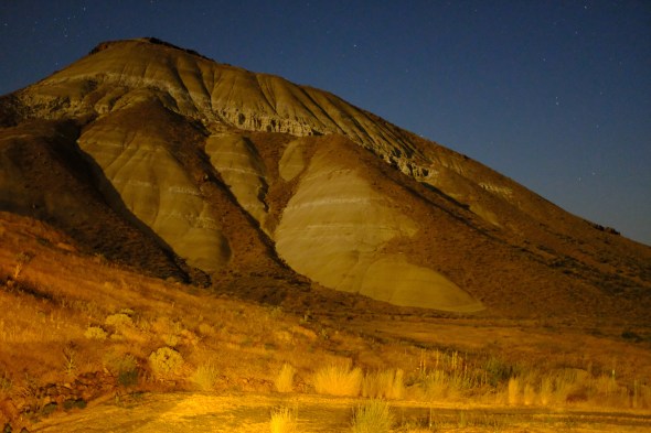 rocky mountain lit by moon