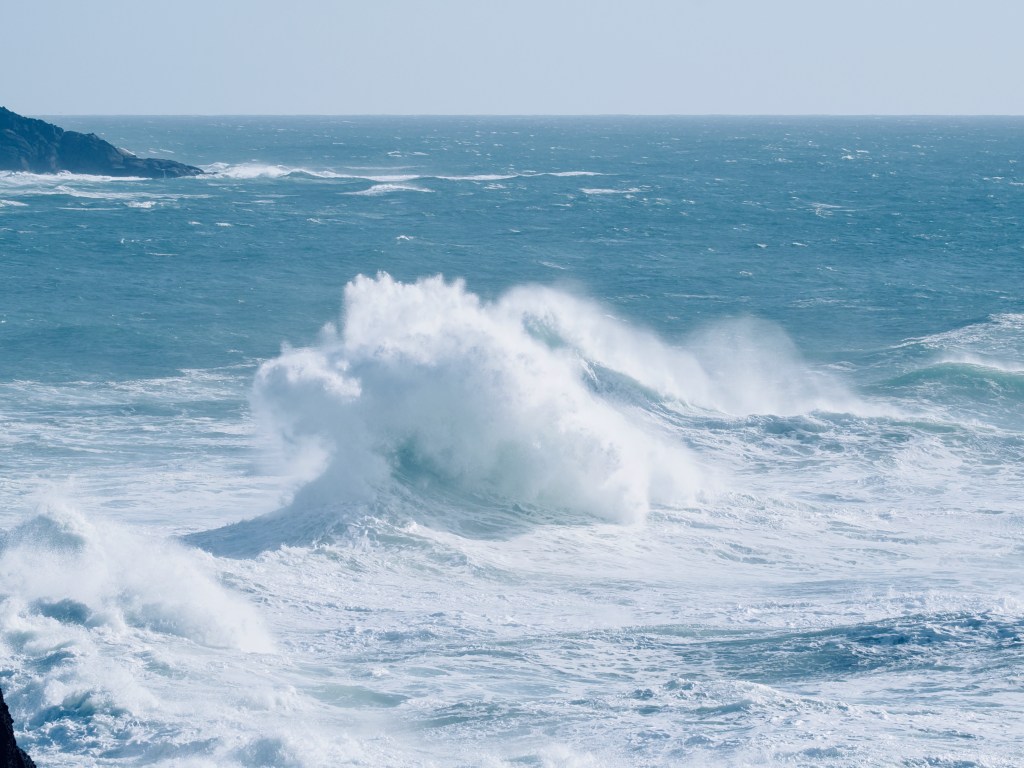 surf and rocky coast with large white breaking waves