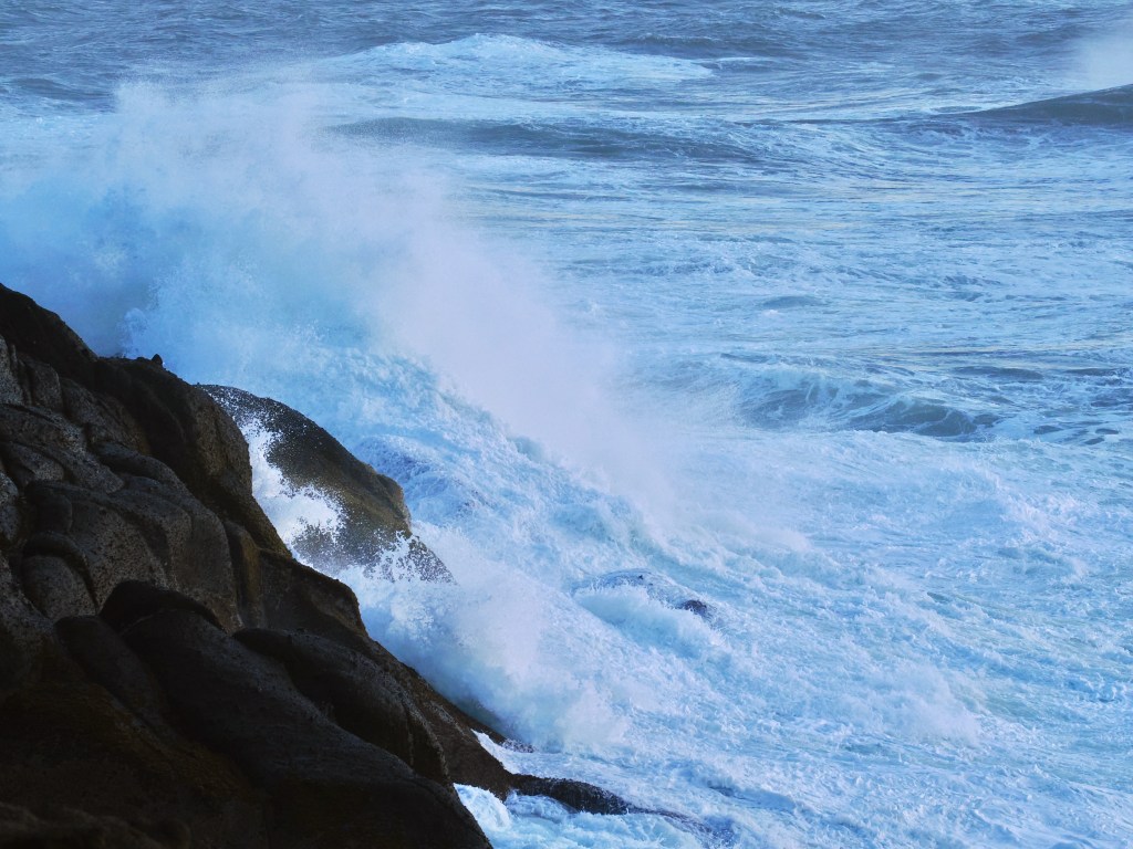 Waves crashing into rocky coast