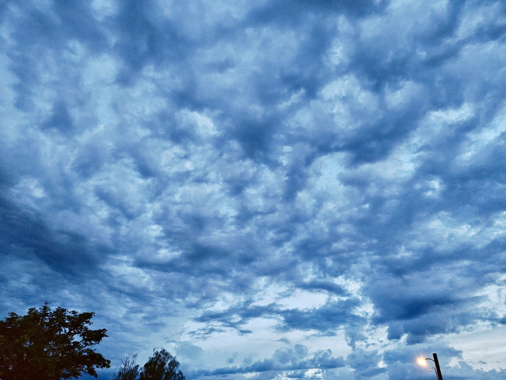 heavy blue-grey clouds in evening sky