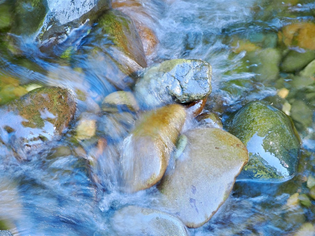 river rocks in rushing water